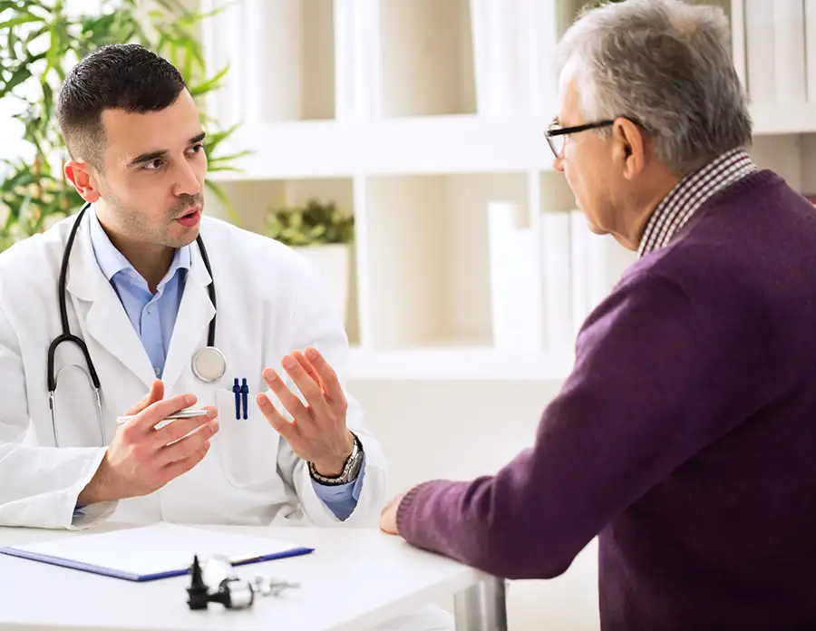 Older man discussing medicare options with his primary care doctor - Collinsville, IL St. Louis Metro East